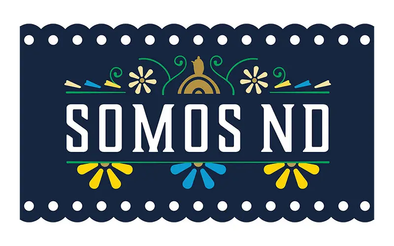 A navy blue rectangular graphic with a scalloped edge features the words SOMOS ND in white. Colorful floral designs and borders surround the text, evoking a festive, papel picado aesthetic. This image celebrates the University of Notre Dame’s Hispanic community.