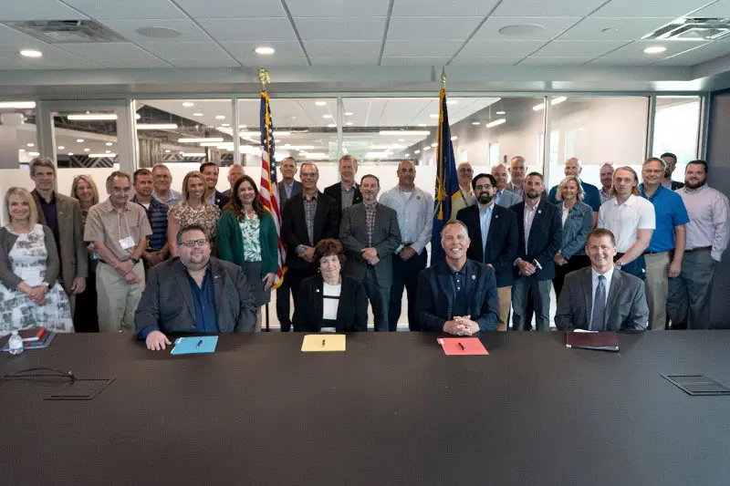 Representatives from Notre Dame, including Vice President for Research Jeff Rhoads; Indiana University, Purdue University and NSWC Crane pose for photo at memorandum of understanding signing