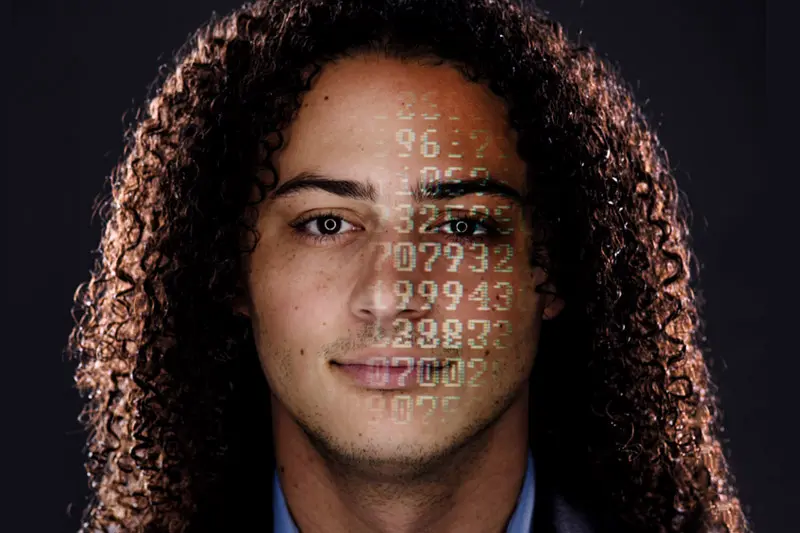 A headshot of Austin Wyman with numbers projected on his face.