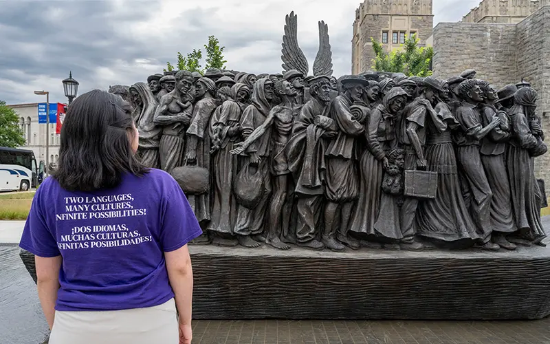 Elsy Pineda gazes at the Angels Unawares sculpture, a bronze sculpture of migrants and refugees from various lands crowded on a 20-foot boat at the Catholic University of America in Washington, D.C. 