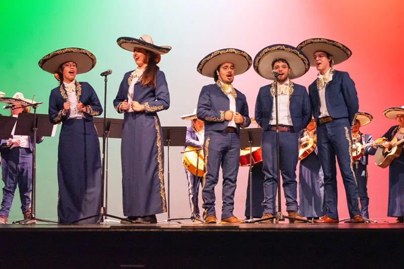 Alan Avalos performs on stage with the Latin Expressions mariachi band