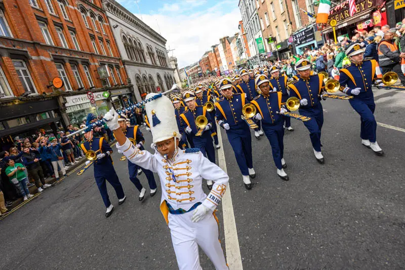 Assistant drum major Savannah Carr stands at the front of a parade with the Notre Dame band in Dublin. 