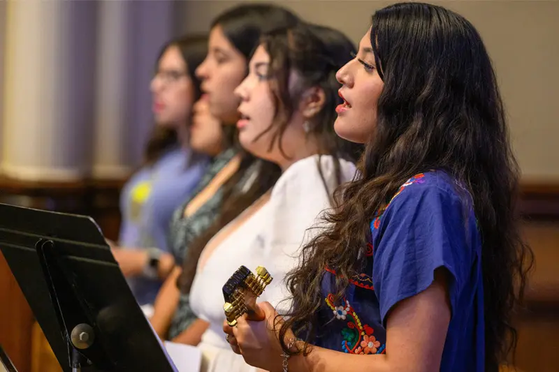 Five women of varying ethnicities sing at the Spanish Mass at the Basilica of the Sacred Heart.