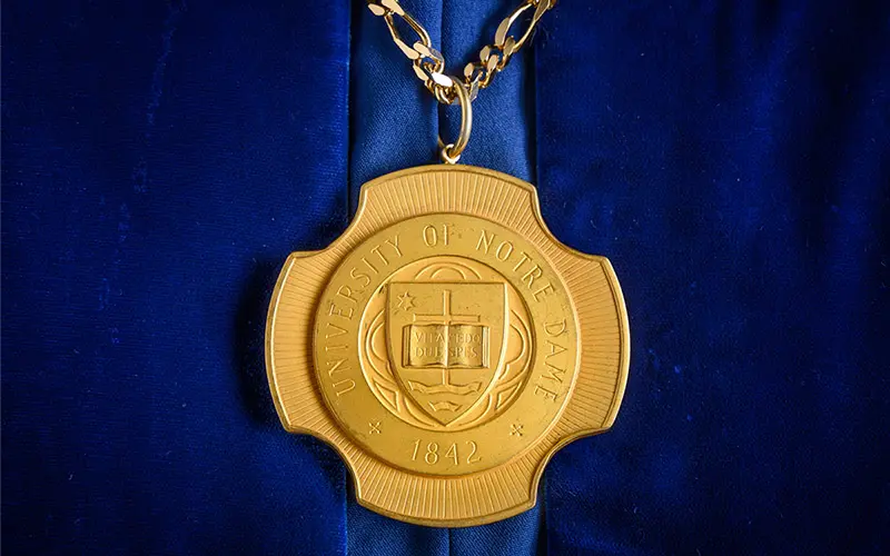 The Presidential medal, a gold circular medal with the University seal in the middle.