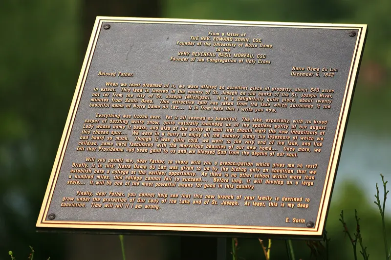 A bronze plaque with writing on it.