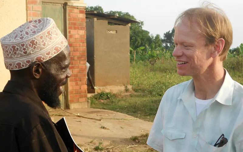 A close up of Father Dowd talking to a black man.