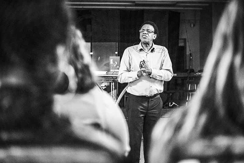 Bishop Thomas Jenkins Sr. stands in front of a room of students.