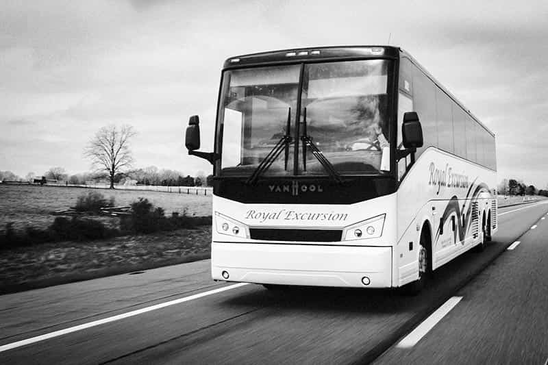 A Royal Excursion bus driving down the highway.