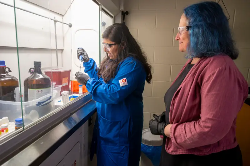 Professor Marya Lieberman works with graduate student Anita Amate in her lab.